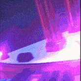 a purple light shines on a white surface