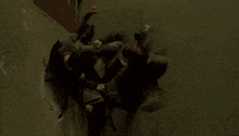 a group of people are fighting each other on a wall