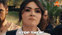 a woman says " stop them " in front of a group of people