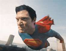 a man in a superman costume is flying over a city