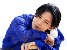 a close up of a person 's face with a blue shirt on