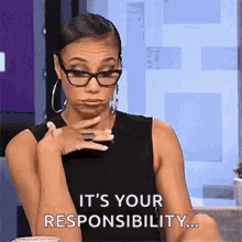 a woman wearing glasses and hoop earrings is making a face and saying `` it 's your responsibility ... ''