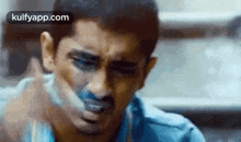 a close up of a man 's face with tape on his mouth .
