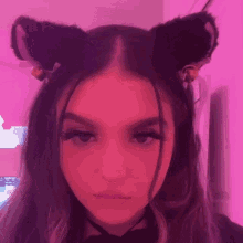 a girl is wearing cat ears and a choker .