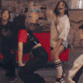 a group of people are dancing in a living room .