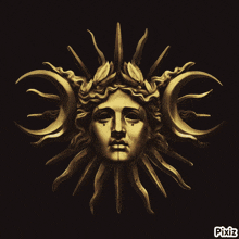 a statue of a woman 's face is surrounded by a sun and moon