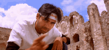 a man wearing a headband that says skinny