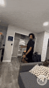 a man in a black shirt is standing in a living room with a sign that says audience
