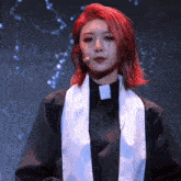 a woman with red hair is wearing a black robe and a white scarf