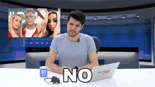 a man sitting at a desk with a laptop that says youtuber news