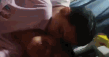 a man and a woman are laying on a bed .