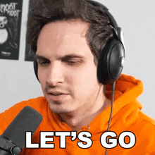 a man wearing headphones says " let 's go "