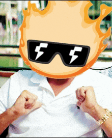 a man wearing sunglasses has a fire head on his face