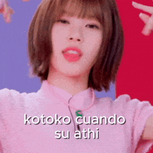 a girl with short hair is wearing a pink shirt and says kotoko cuando su athi .