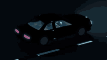 a car is driving down a road at night with a purple light on the back