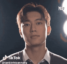 a close up of a young man 's face with a tik tok watermark