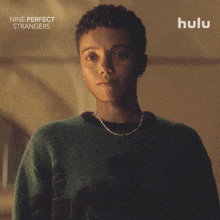 a poster for nine perfect strangers shows a woman in a green sweater and says i 'm listening