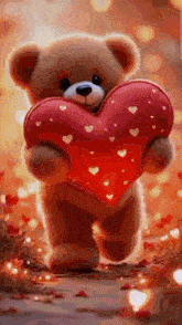a teddy bear is holding a large red heart in its hands .