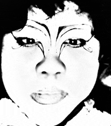 a black and white photo of a woman 's face with makeup on