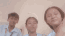a girl wearing a lanyard that says ' philippines ' on it laughs with another girl