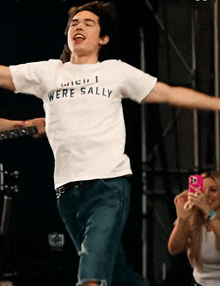 a man wearing a white shirt that says ' when i were sally ' on it
