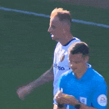 a soccer player wearing a white jersey that says ' sporting ' on the front