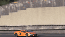 an orange sports car with the number 4 on the side of it