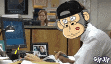 a gif of a monkey sitting at a desk with a pen in his hand