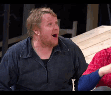 a man with a beard is making a surprised face with his mouth open