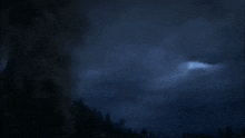 a dragon is flying through the air with a flame coming out of it 's mouth