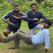 three men are posing for a picture and one of them has the name sanjo written on the bottom