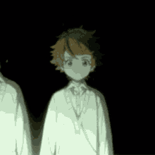 a girl with brown hair is standing in a dark room