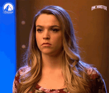 a woman 's face is shown in front of a paramount logo for ink master