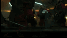 a group of people in red jumpsuits are dancing in a room