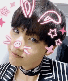 a close up of a person 's face with bunny ears and pink stars on it .