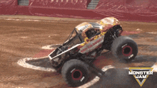 a monster jam truck is driving through a muddy area
