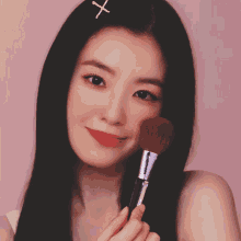 a woman with a cross in her hair holds a brush