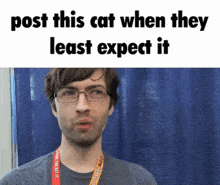 a man wearing glasses stands in front of a blue curtain with the words post this cat when they least expect it at the top