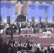 a crowd of people are sitting in a church and a man is standing in front of them .