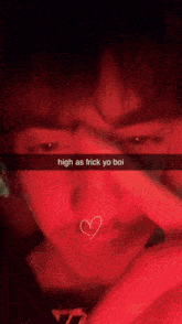 a close up of a man 's face with a heart in his mouth and the words high as frick yo boi