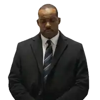 a man in a suit and tie is praying with his eyes closed