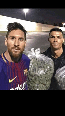 a man in a nike shirt is standing next to a man holding a bag of marijuana .