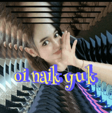 a woman taking a selfie with the words " oi naik yuk " behind her