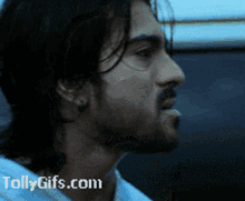 a close up of a man 's face with the website tollygifs.com visible in the corner