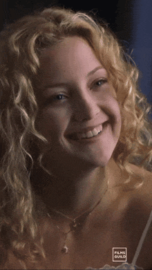a woman with curly hair is smiling and the words me too are above her