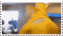 a blurred image of a yellow object with a blue background