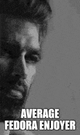 a black and white photo of a man with a beard with the words `` average fedora enjoyer '' written on it .
