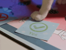 a piece of paper with a green check mark and the word yes on it