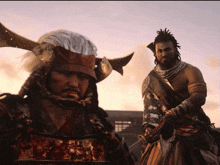 a man in a samurai costume holds a sword next to another man