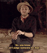 a man in a cowboy hat is kneeling down and saying so you know can 't judge someone for that
